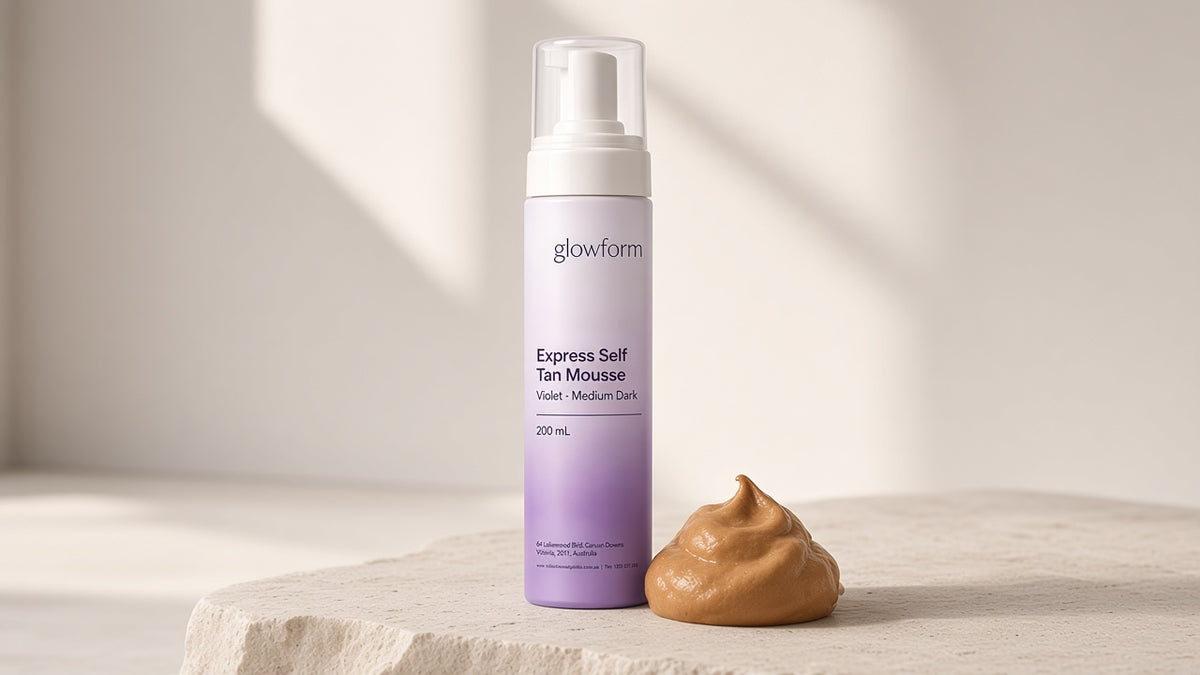 A swirl of tan-coloured Glowform mousse beside the violet bottle, showing the instant guide colour
